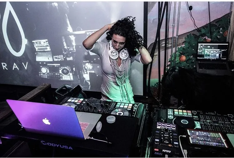 Merav in front of the DJ Merav backdrop